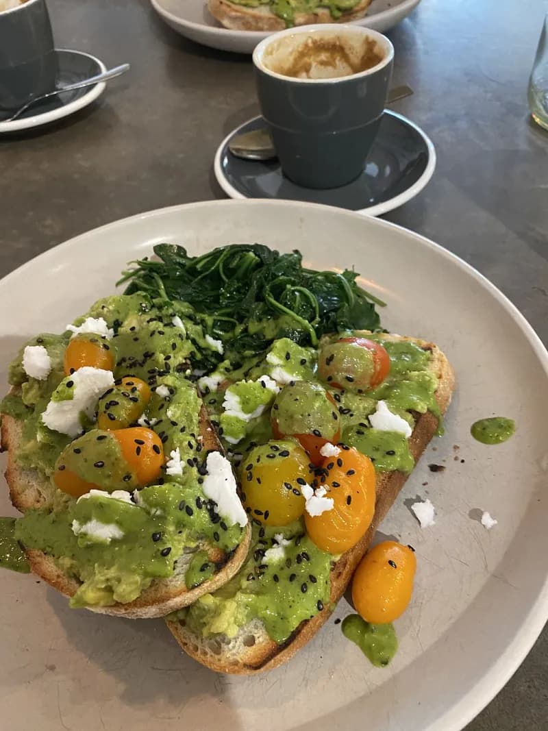 Avocado toast with cherry tomatoes, feta and fresh greens
